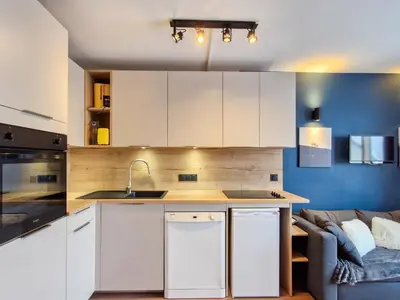a kitchen with white cabinets and a couch at Appartement Sud Confort 4-5 pers, Balcon, Proche pistes - FR-1-425-173 in Flaine