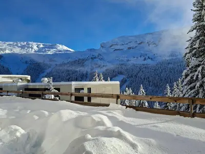a snow covered mountain with a fence and trees at Studio confortable au centre station avec terrasse, animaux admis - FR-1-425-181 in Flaine
