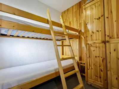 a couple of bunk beds in a room with a ladder at Studio cabine confortable à Flaine, balcon sud, proche pistes - FR-1-425-171 in Flaine