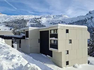a building in the snow with mountains in the background at Studio cabine confortable à Flaine, balcon sud, proche pistes - FR-1-425-171 in Flaine