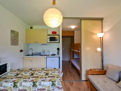a small room with a bed and a kitchen at Studio confortable avec balcon au centre de Flaine - FR-1-425-174 in Flaine
