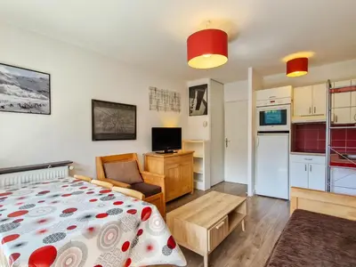 a small apartment with a bed and a kitchen at Appartement confortable avec balcon et parking couvert - FR-1-425-143 in Flaine