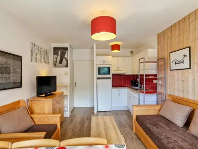 a living room with a couch and a kitchen at Appartement confortable avec balcon et parking couvert - FR-1-425-143 in Flaine