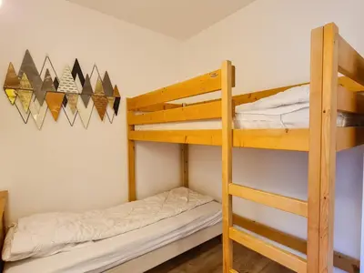a bedroom with two bunk beds and a ladder at Appartement confortable avec balcon et parking couvert - FR-1-425-143 in Flaine