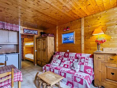 a living room with a couch and a table in a cabin at Studio rénové à Flaine - 4 pers. proche des pistes - FR-1-425-178 in Flaine