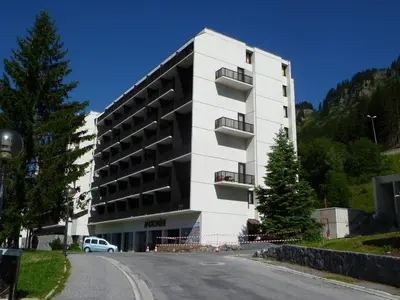 a large white building on the side of a road at Studio rénové à Flaine - 4 pers. proche des pistes - FR-1-425-178 in Flaine