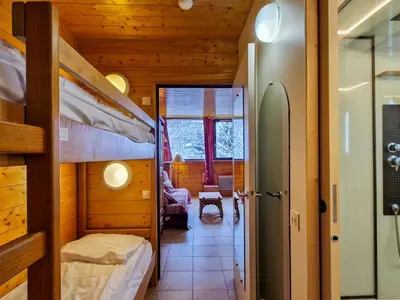 a room with two bunk beds and a living room at Studio rénové à Flaine - 4 pers. proche des pistes - FR-1-425-178 in Flaine