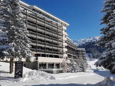 a large building with snow in front of it at Appartement au pied des pistes avec piscine et parking - FR-1-425-189 in Flaine