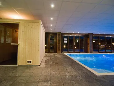 an empty swimming pool in a building with a building at Appartement au pied des pistes avec piscine et parking - FR-1-425-189 in Flaine