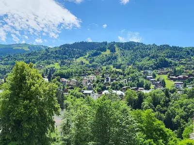 a town in a valley with trees and houses at Appartement dans châlet avec piscine couverte in Saint-Gervais-les-Bains