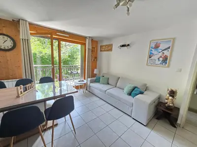a living room with a couch and a table at Appartement dans châlet avec piscine couverte in Saint-Gervais-les-Bains