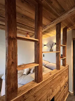 two beds in a room with wooden beams at Le Nid de l'Aiguille - Au pied de l'Aiguille du midi in Chamonix-Mont-Blanc