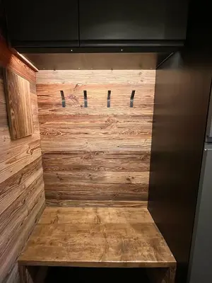 a wood paneled wall in a kitchen with a bench at Le Nid de l'Aiguille - Au pied de l'Aiguille du midi in Chamonix-Mont-Blanc