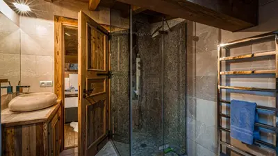 a bedroom with a bed and a large window at Chalet Entre Nous in Chamonix-Mont-Blanc