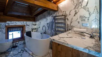 a bedroom with a large bed with towels on it at Chalet Entre Nous in Chamonix-Mont-Blanc