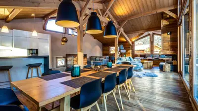 a dining room with a large wooden table and chairs at Chalet du Bois in Chamonix-Mont-Blanc