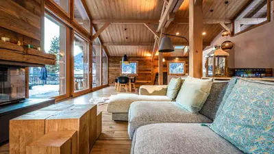 a living room with two couches and a fireplace at Chalet du Bois in Chamonix-Mont-Blanc