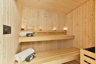 a sauna with two towels and candles in it at Chalet du Bois in Chamonix-Mont-Blanc