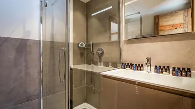 a bathroom with a shower and a sink at Chalet du Bois in Chamonix-Mont-Blanc