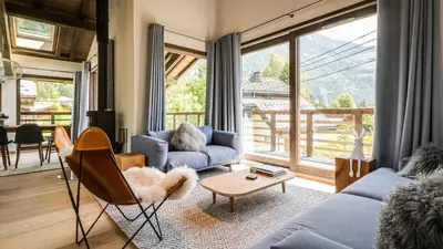 a kitchen with white cabinets and a sink and a window at Chalet Etoile in Chamonix-Mont-Blanc