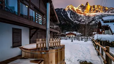 two chairs on a deck with a view of a mountain at Chalet Etoile in Chamonix-Mont-Blanc