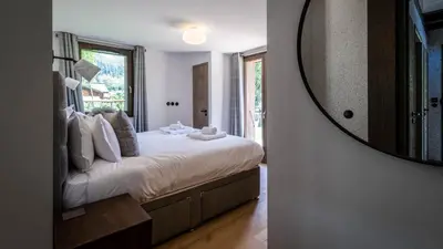a bedroom with a bed with towels and pillows at Chalet Etoile in Chamonix-Mont-Blanc