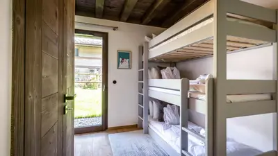 a bedroom with a large white bed with towels on it at Chalet Etoile in Chamonix-Mont-Blanc