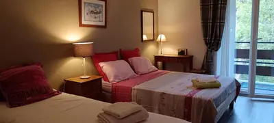 a hotel room with two beds and a window at LE PARADISO centre SAINT-GERVAIS in Saint-Gervais-les-Bains