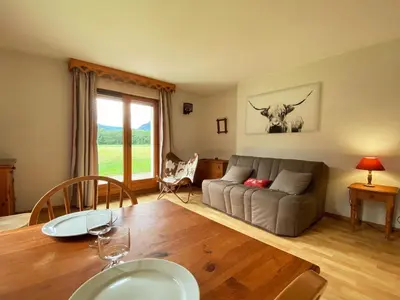 a living room with a couch and a table at Studio avec vue montagnes et piscines, animaux acceptés - FR-1-624-108 in Samoëns