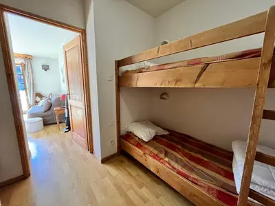 a bedroom with two bunk beds and a mirror at Studio avec vue montagnes et piscines, animaux acceptés - FR-1-624-108 in Samoëns