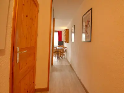 an open door to a dining room with a table at Bel appartement 36m² rénové, sans internet, 2 ch, 6 couchages à Morillon - FR-1-642-67 in Morillon