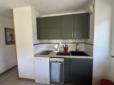 a small kitchen with a sink and a stove at Bel appartement 36m² rénové, sans internet, 2 ch, 6 couchages à Morillon - FR-1-642-67 in Morillon