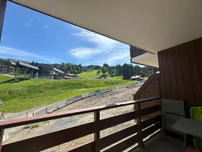 a group of people sitting in chairs in the snow at Bel appartement 36m² rénové, sans internet, 2 ch, 6 couchages à Morillon - FR-1-642-67 in Morillon