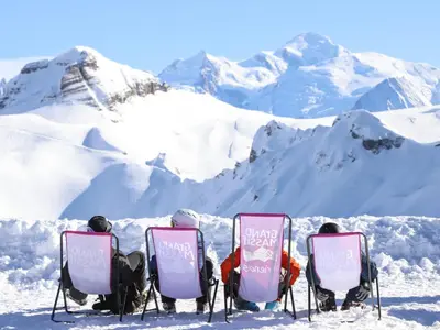 three people on a ski lift in the mountains at Bel appartement 36m² rénové, sans internet, 2 ch, 6 couchages à Morillon - FR-1-642-67 in Morillon