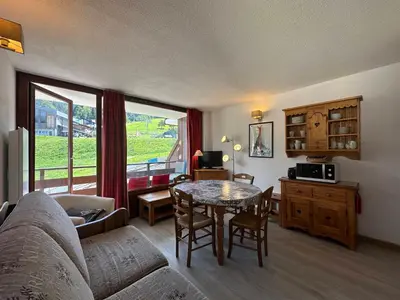a living room with a couch and a table at Bel appartement 36m² rénové, sans internet, 2 ch, 6 couchages à Morillon - FR-1-642-67 in Morillon