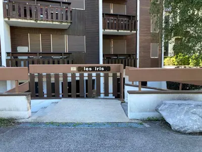 two park benches sitting in front of a building at Studio cosy au centre de Samoëns, animaux acceptés - FR-1-624-110 in Samoëns