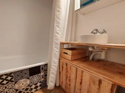 a bathroom with a sink on a wooden counter at Studio cosy au centre de Samoëns, animaux acceptés - FR-1-624-110 in Samoëns