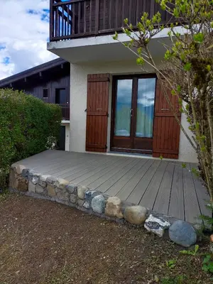 a house with a wooden deck with a balcony at Appartement - Combloux in Combloux