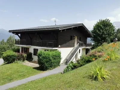 a house on a hill with a pathway in front of it at Appartement - Combloux in Combloux