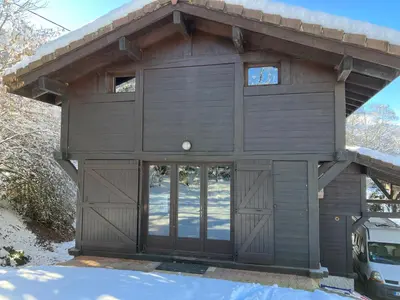 a large brown garage with a large glass door at Chalet Le Paddock in Saint-Gervais-les-Bains