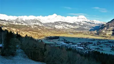 a view of a valley with snow covered mountains at Chalet Le Paddock in Saint-Gervais-les-Bains