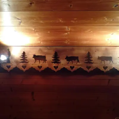a painting of cows and trees on a wall at Chalet Le Paddock in Saint-Gervais-les-Bains