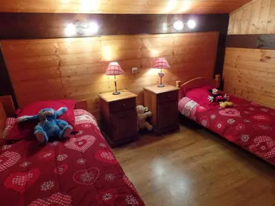 a bedroom with two beds with stuffed animals on them at Chalet Le Paddock in Saint-Gervais-les-Bains