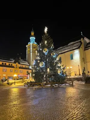 a christmas tree in front of a building at Le Sapin B19 Megeve - Demi Quartier in Megève