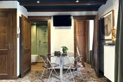 a dining room with a glass table and a shower at Tatiana 2 in Megève