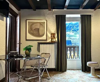 a dining room with a table and chairs and a window at Tatiana 2 in Megève
