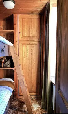 a room with a bunk bed and a ladder at Tatiana 2 in Megève