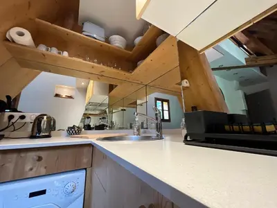 a kitchen with a sink and a counter top at un nid sous les toits in Saint-Gervais-les-Bains