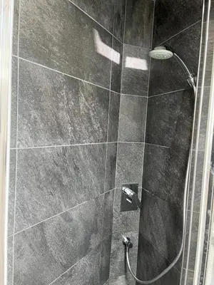 a bathroom with a shower with a glass door at un nid sous les toits in Saint-Gervais-les-Bains