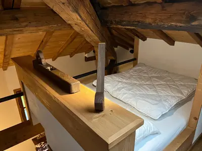 a room with a bed and a hammer on a counter at un nid sous les toits in Saint-Gervais-les-Bains